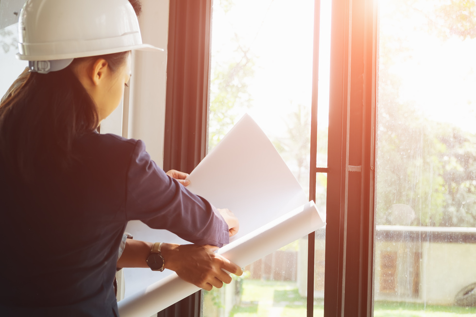 Close Up of Architects Working on Blueprint